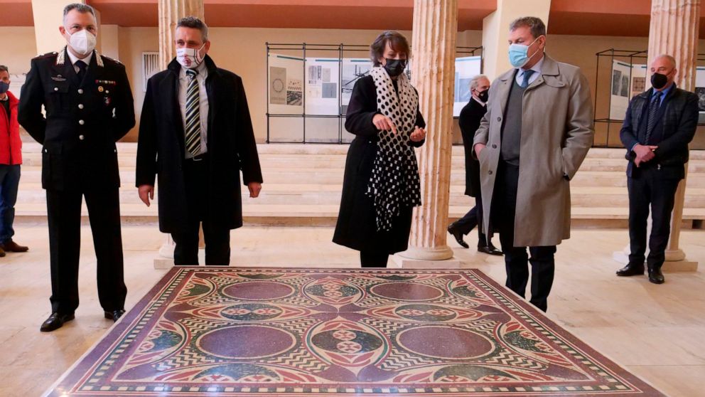Authorities stand around a 1.5 square meter colorful mosaic dating back to 40 A.D. and belonging to the flooring of Caligula’s lavish ceremonial ships, that was found thanks to a joint police operation in the rooms of a Manhattan house and returned t